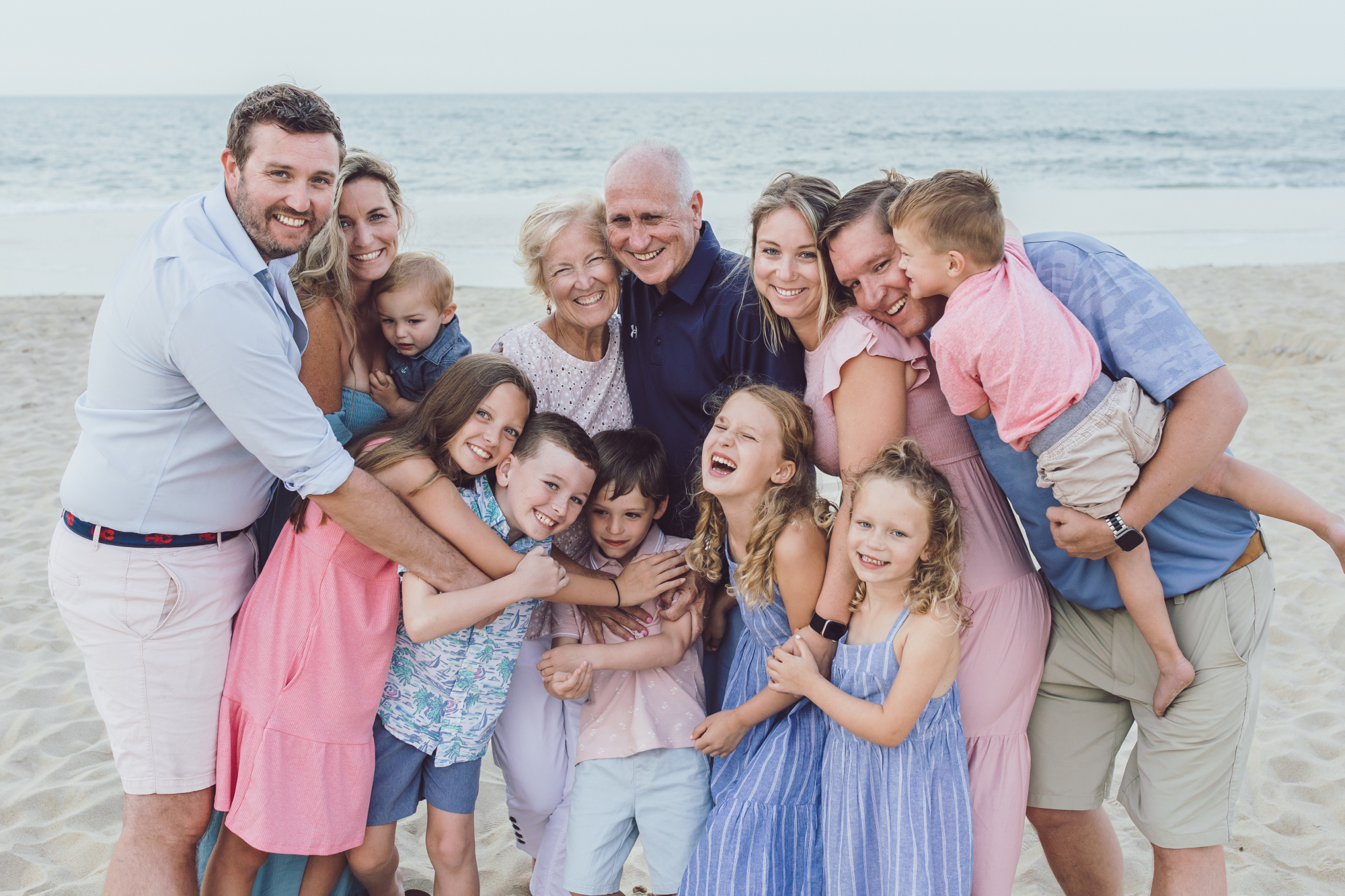 Family walking together along Dewey Beach shoreline